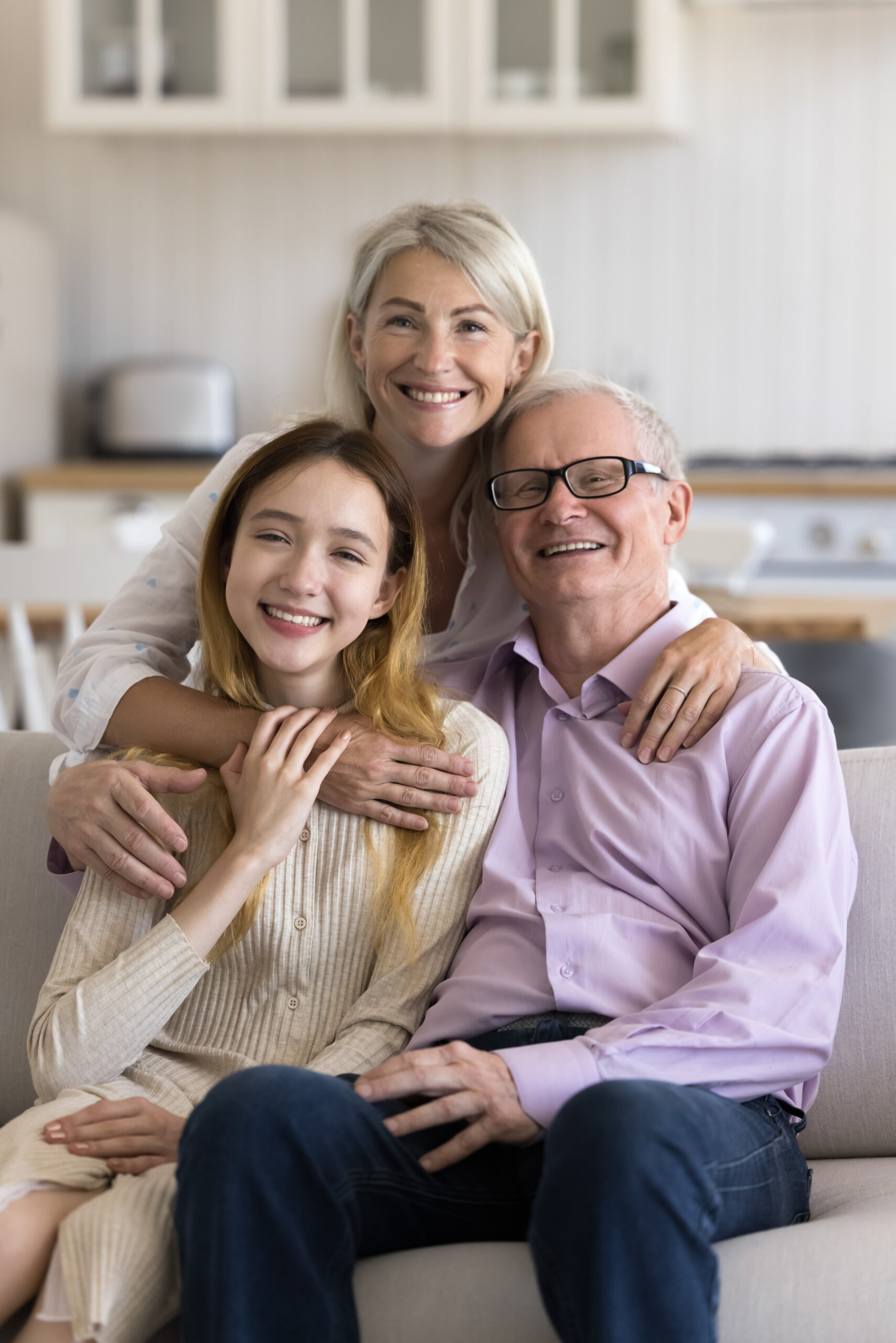 Cheerful grandparents and grandkid home family portrait